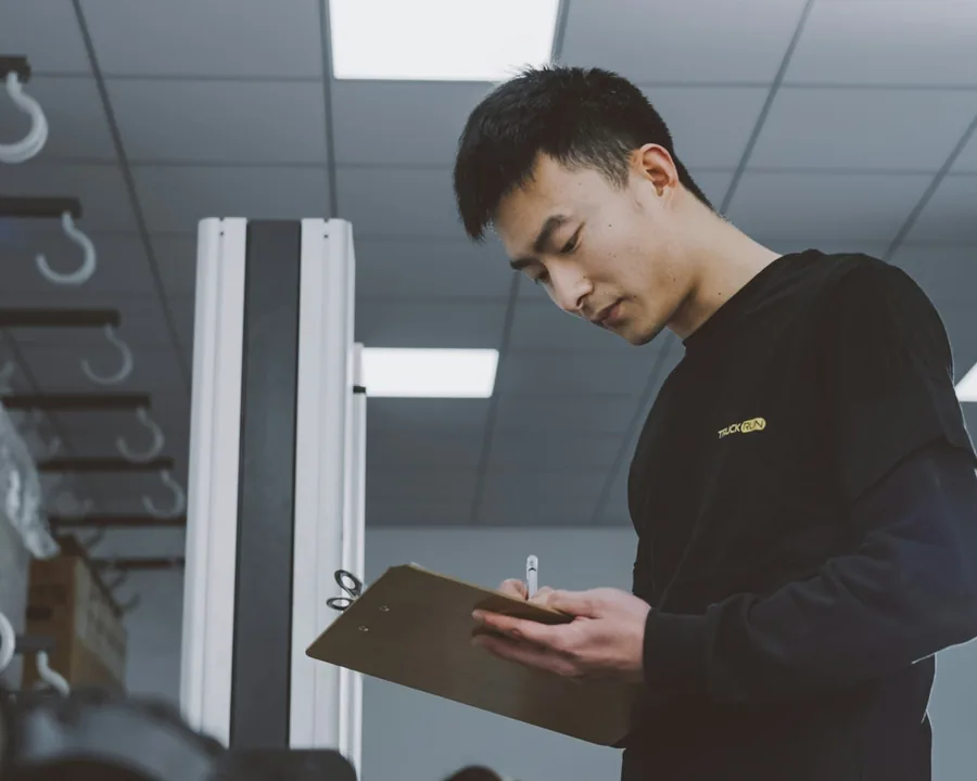 Person checking items against a clipboard