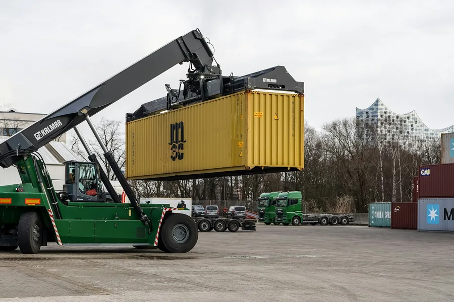 Reach stacker lifting a container at a terminal