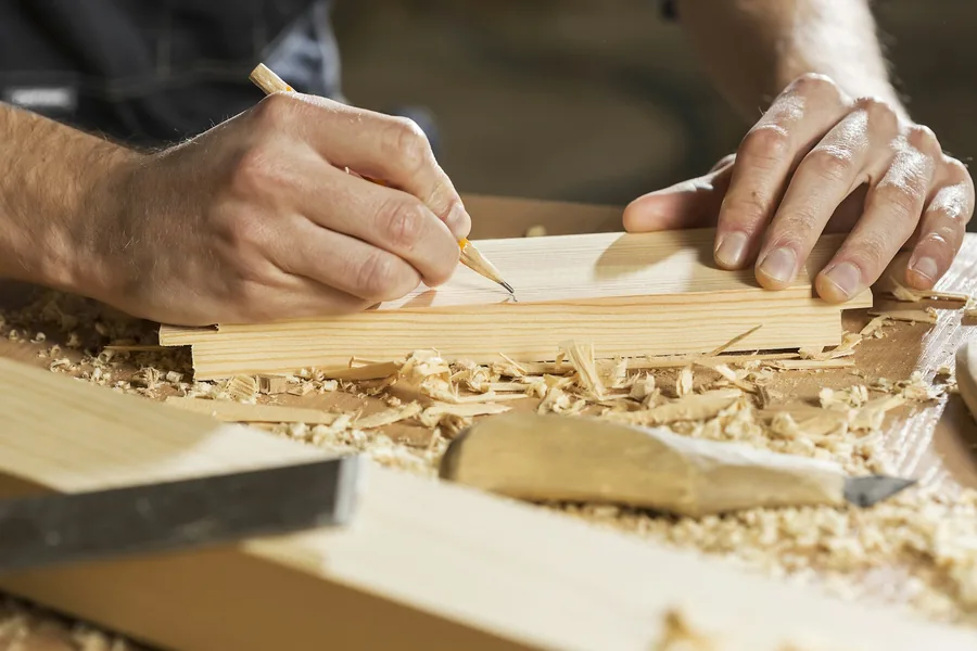 Carpenter marking a timber board