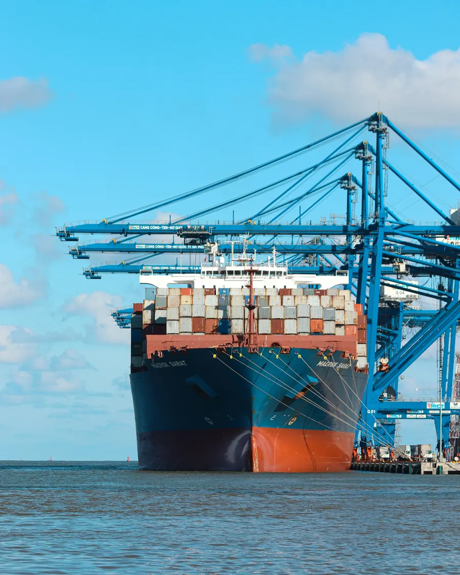 Container ship moored under ship-to-shore cranes