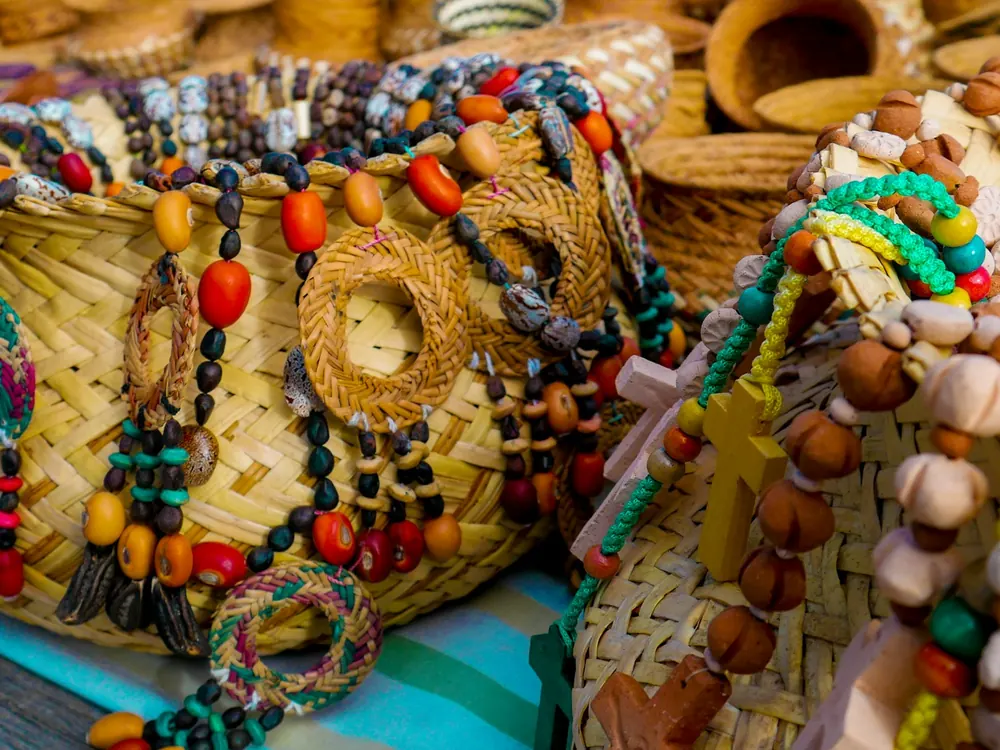 Woven baskets decorated with coloured beads and seed charms