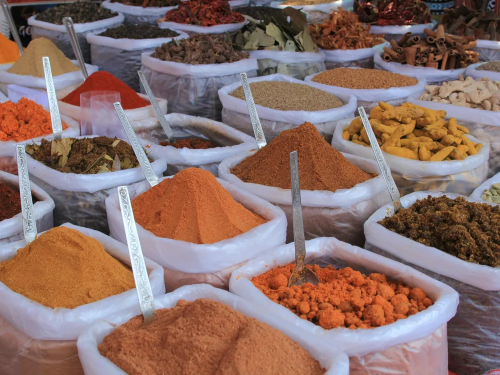 Open sacks of spices and dried herbs at a market stall