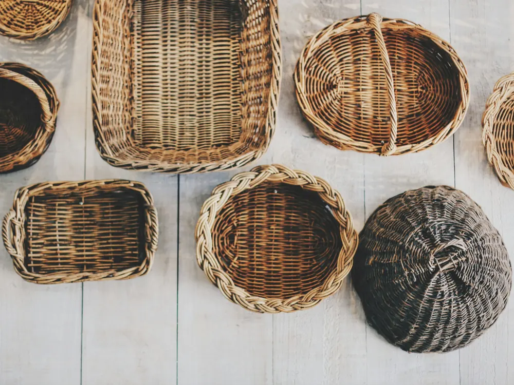 Woven wicker baskets laid out on a wooden floor
